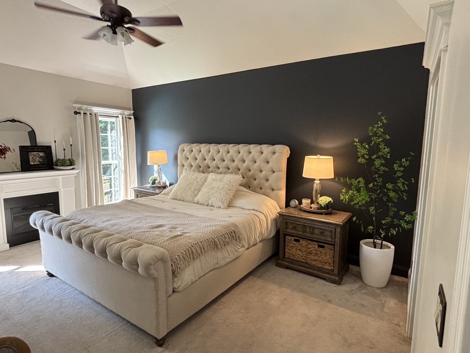 Primary bedroom with navy blue accent wall painted by Trifecta Painting in Cedar Pointe, Corydon IN