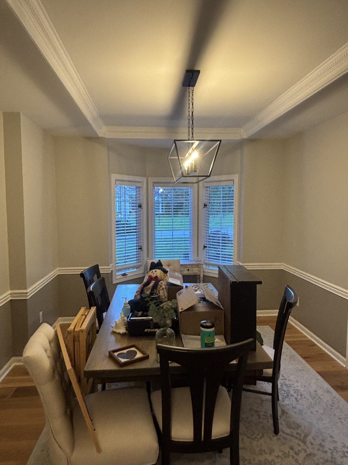Dining room with two-tone walls and wainscoting after interior painting in Plum Lake, Sellersburg IN