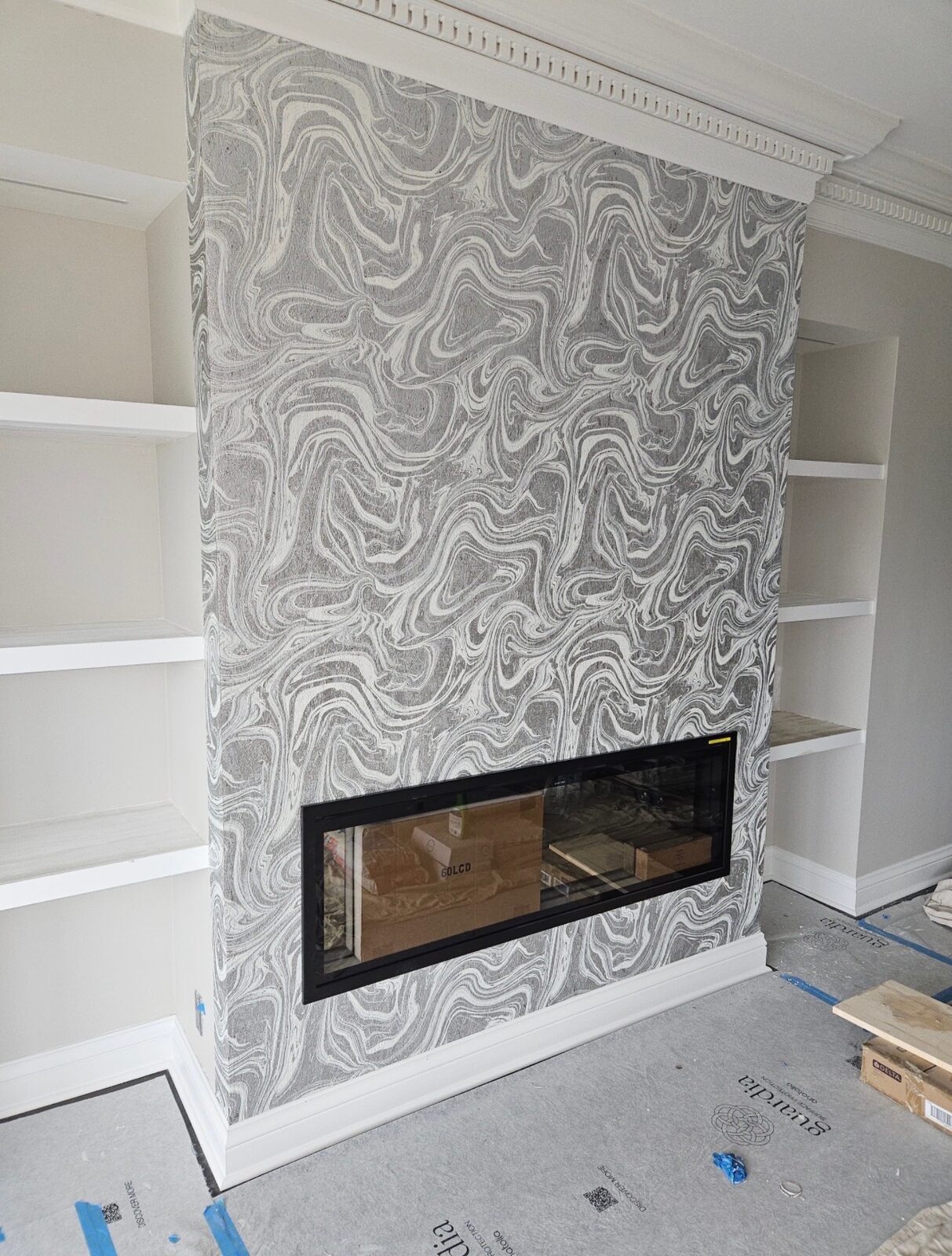 Fireplace accent wall with marble swirl wallpaper installed in Louisville, KY