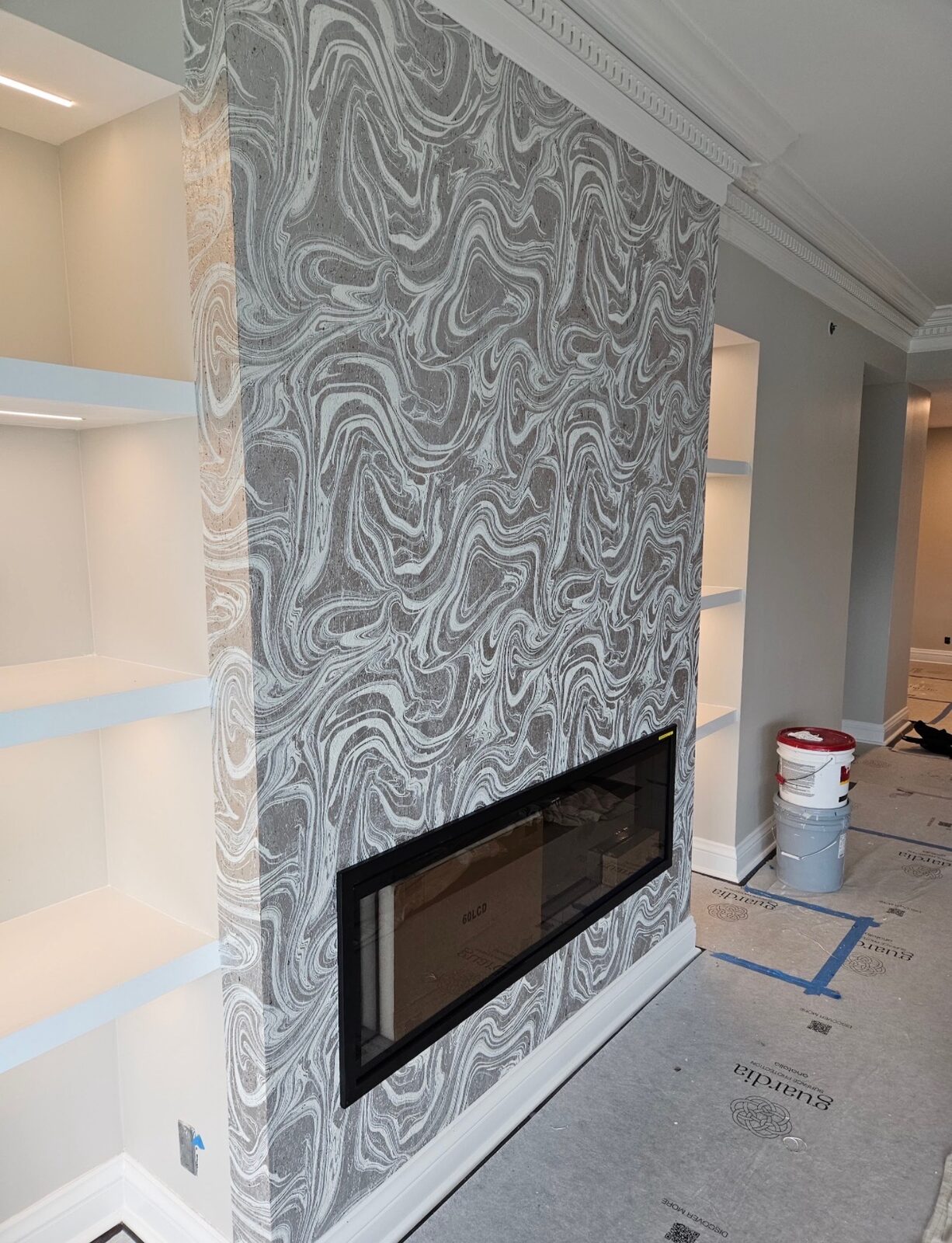 Detail of marble swirl wallpaper on a fireplace accent wall in Louisville, KY