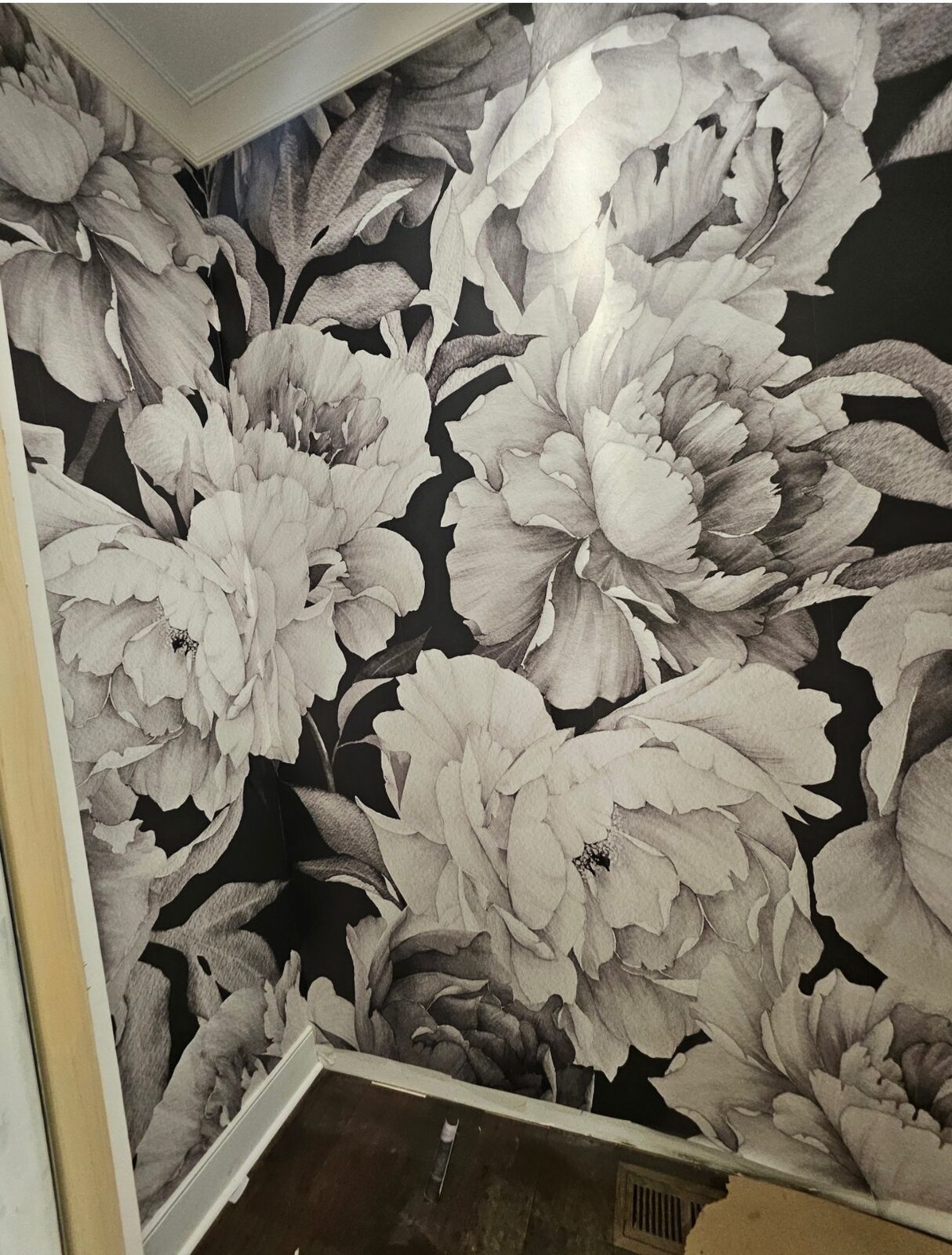 Detail of black and white peony wallpaper installation in a Louisville, KY powder room
