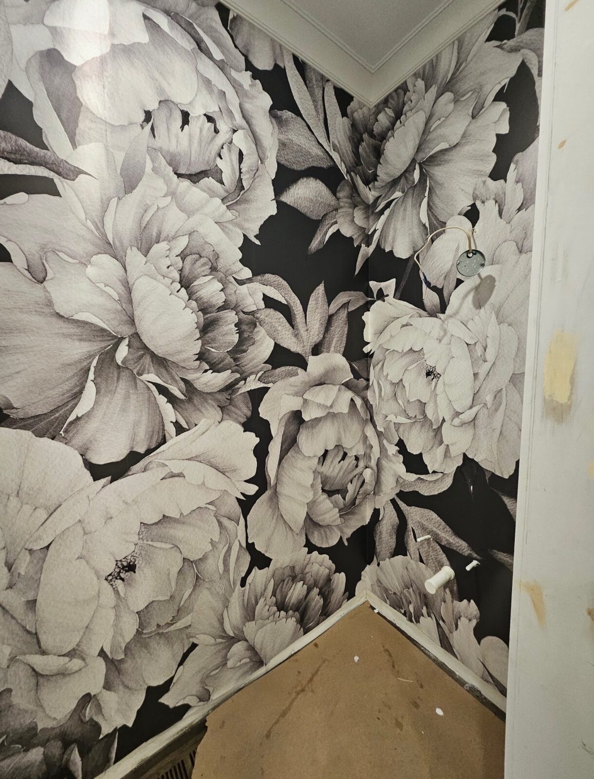 Powder room with black and white peony floral wallpaper installed in Louisville, KY