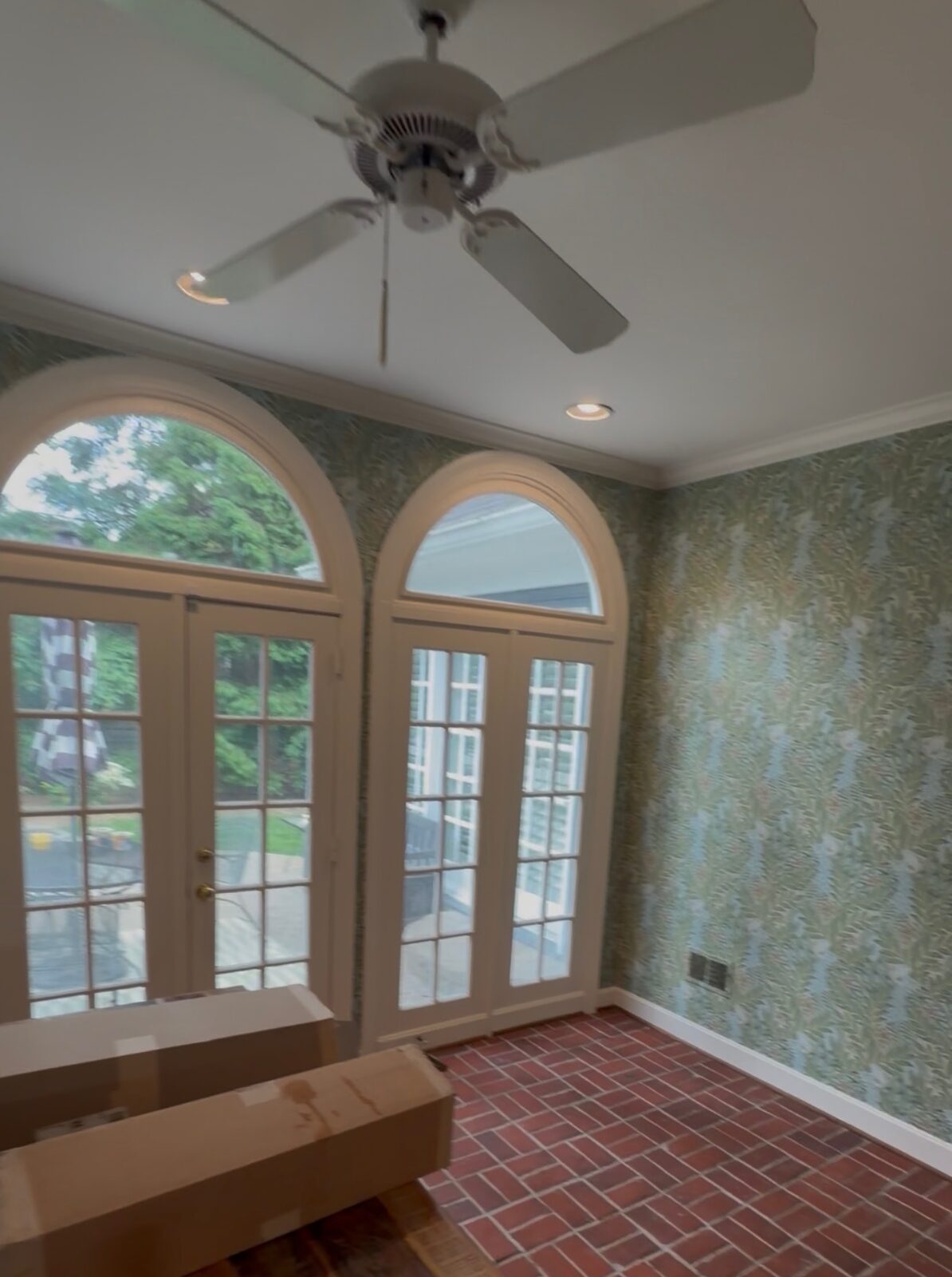 Sunroom with green botanical print wallpaper installed in Louisville, KY